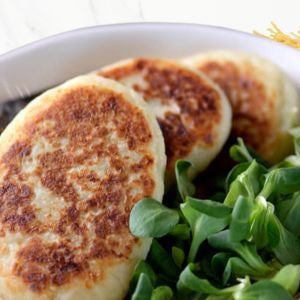 Golden-brown bubble & squeak potato cakes with fresh green salad, perfect for baby-led weaning.
