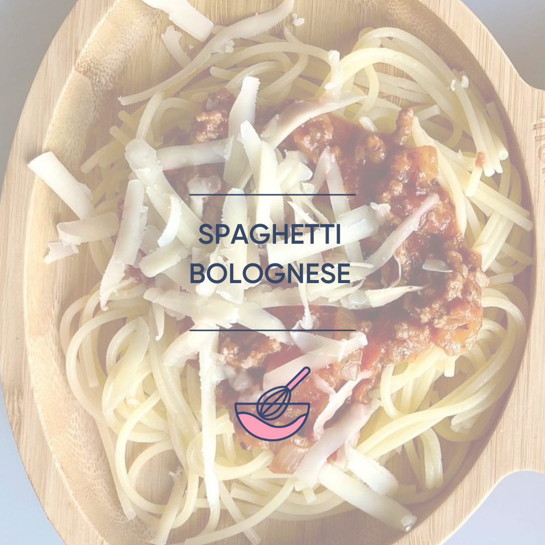 Spaghetti Bolognese in a wooden bowl, topped with grated cheese.