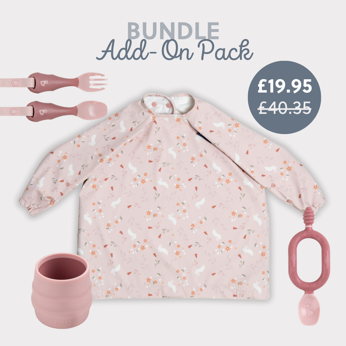 Pink long-sleeved bib with bunny print, matching silicone cup, fork, spoon, and teether. - Product image