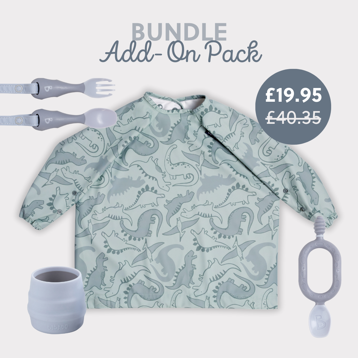 Sage green long-sleeve dinosaur bib, grey silicone cup, fork, spoon, and teether. - Product image