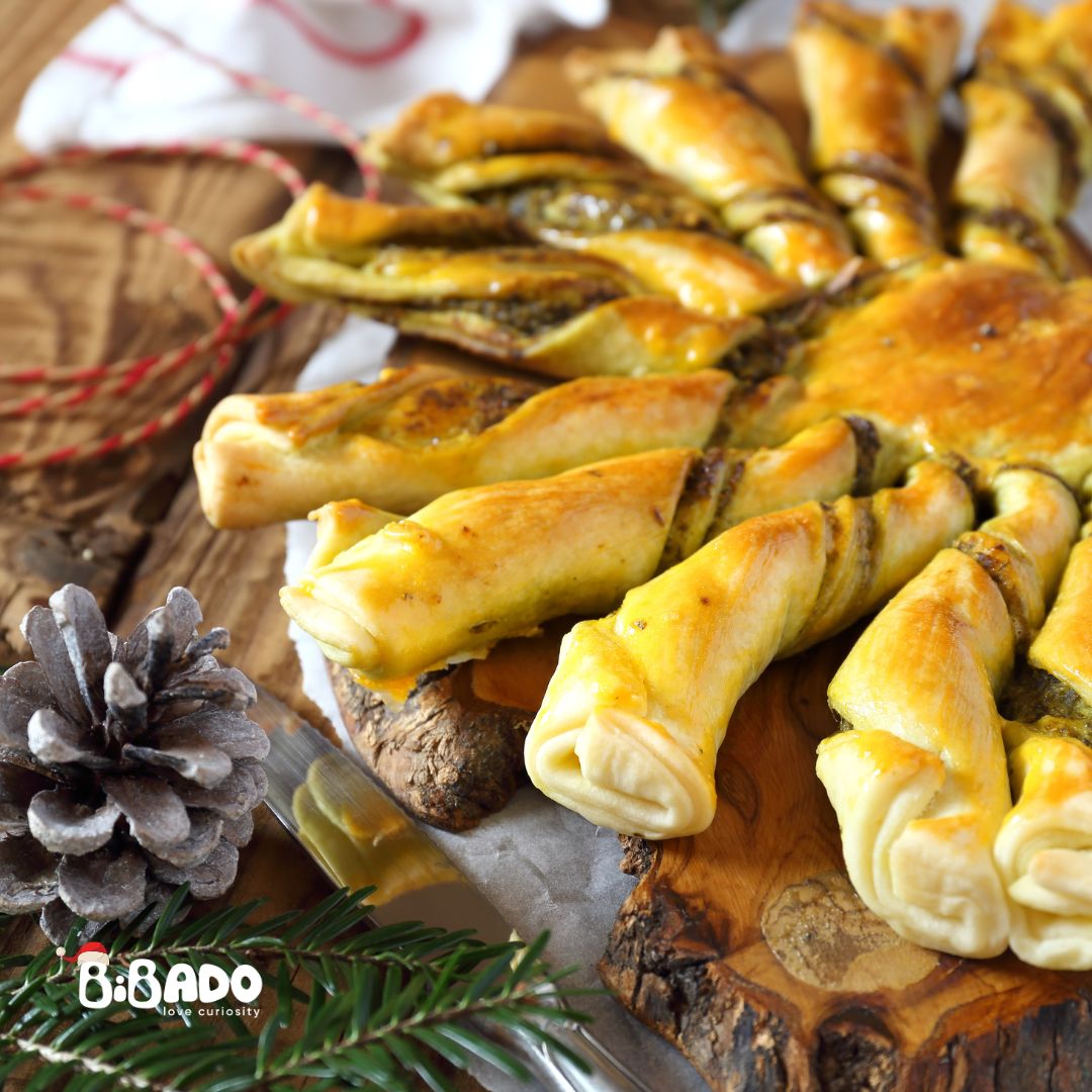 Golden baked pesto and cheese tear-n-share bread on a rustic wooden board with a pine cone.