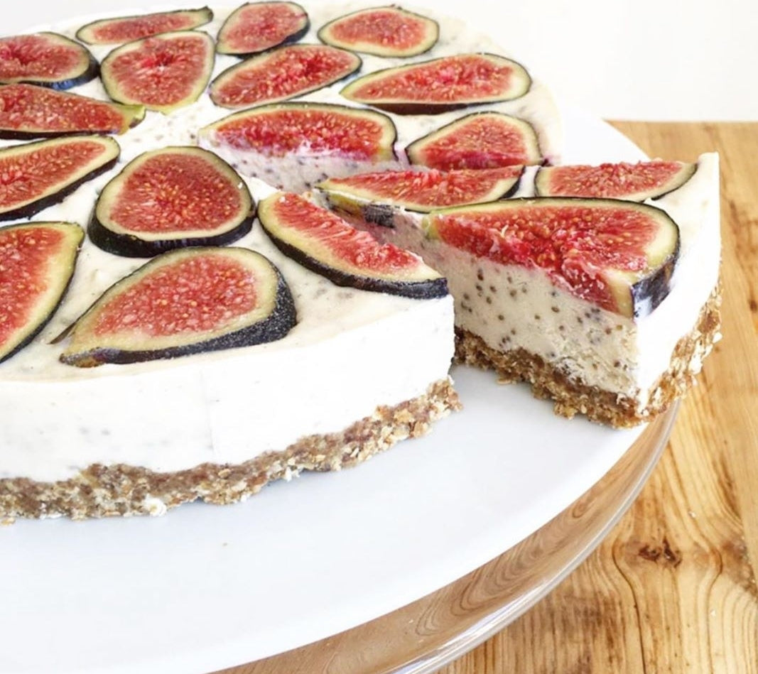 Creamy fig pie with a slice removed, revealing a seeded filling and crumbly base.