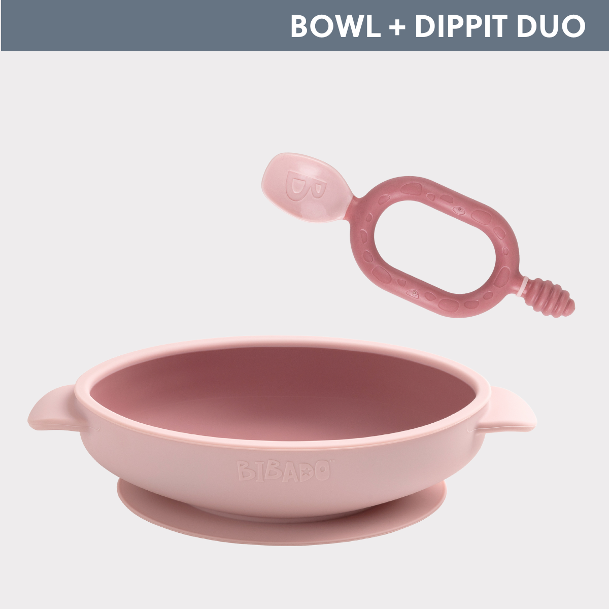 Pink silicone weaning bowl with suction base and matching Dippit spoon. - Product image