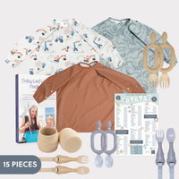 Daddy Bear Bundle: 3 long-sleeve weaning bibs (truck, dinosaur, rainbow), 2 training cups, cutlery sets, and recipe book. - Product image