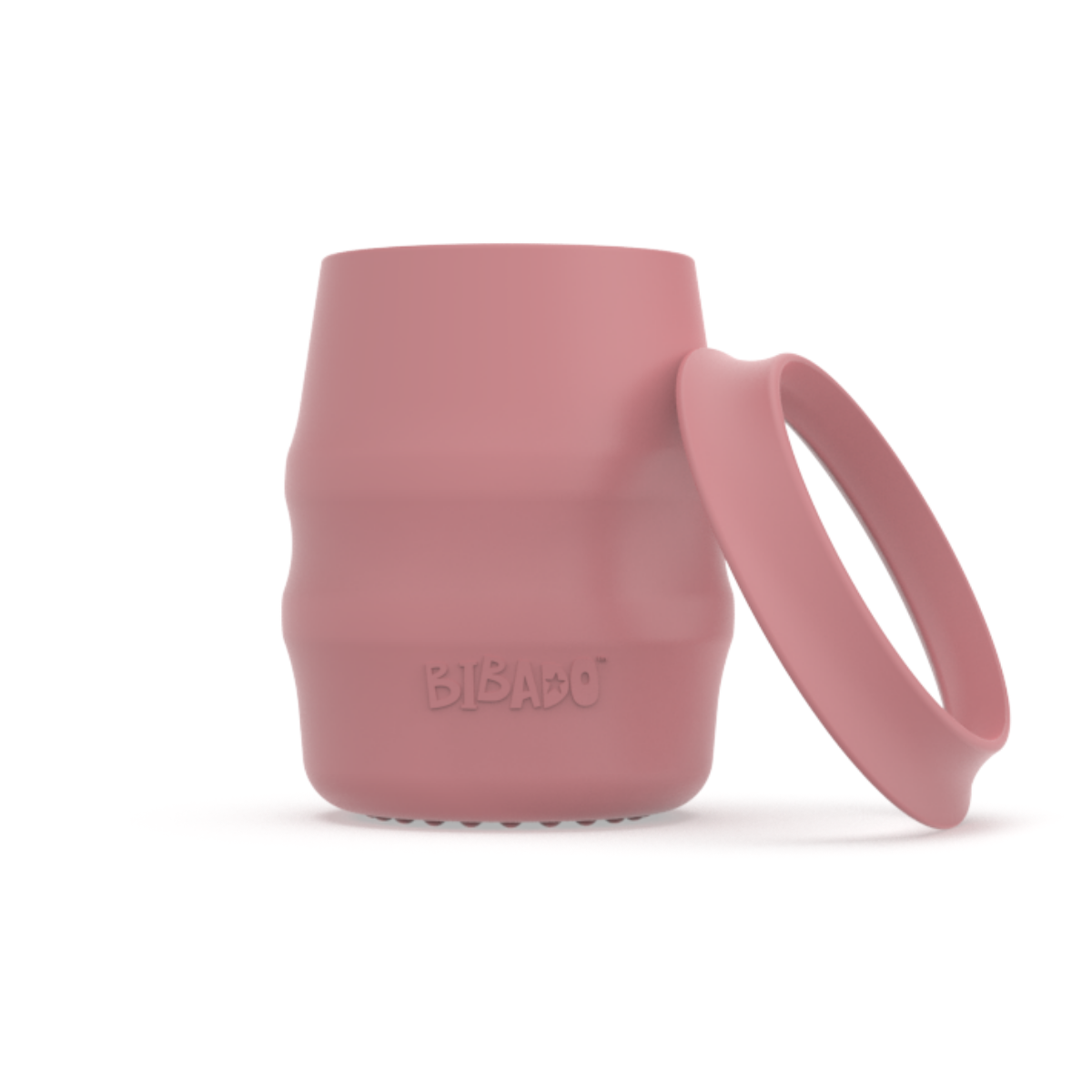 A pink silicone baby drinking cup with a removable silicone skirted base propped against it, shown on a clean white background.  - Product image