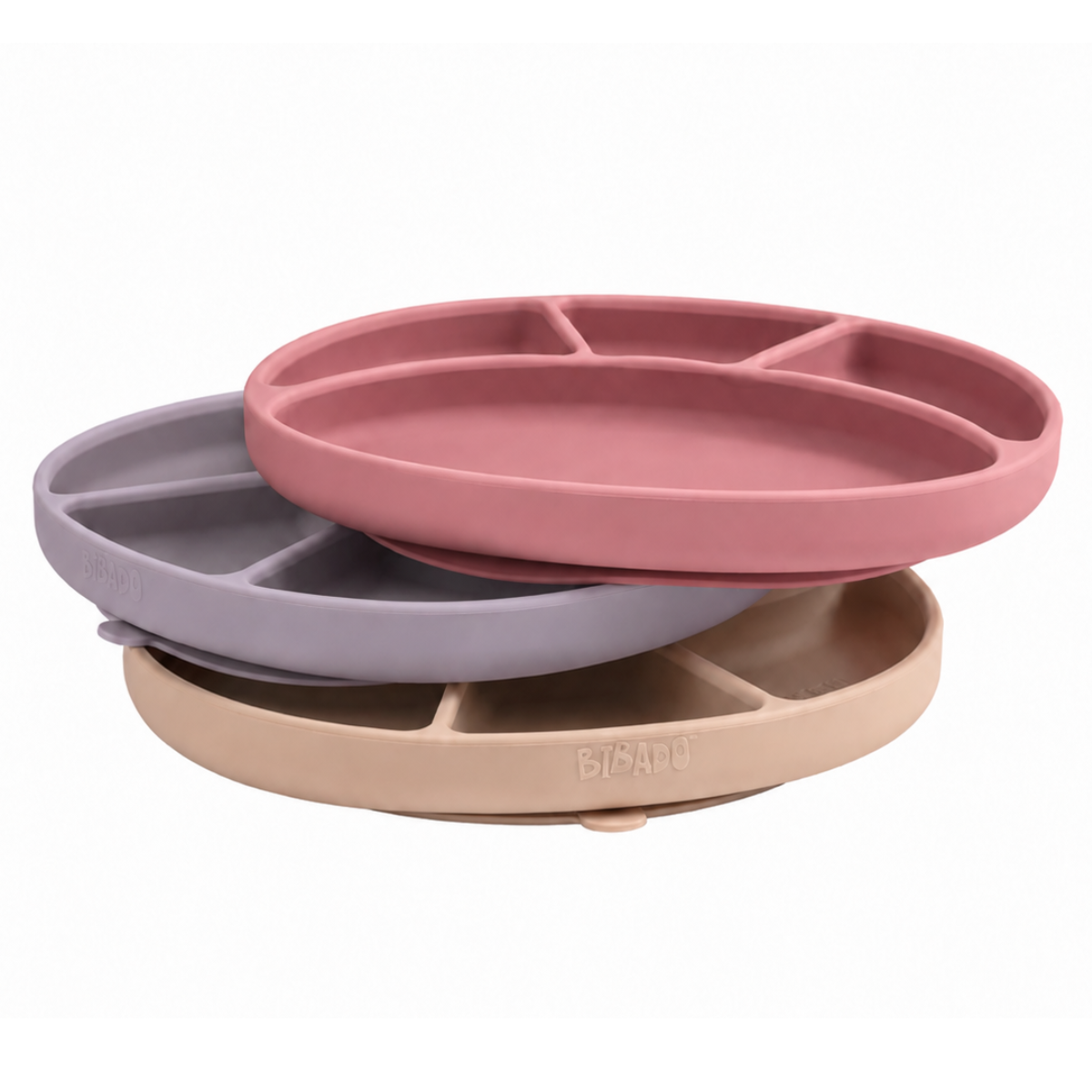 Three silicone plates in mist, blush, and fawn on a white background