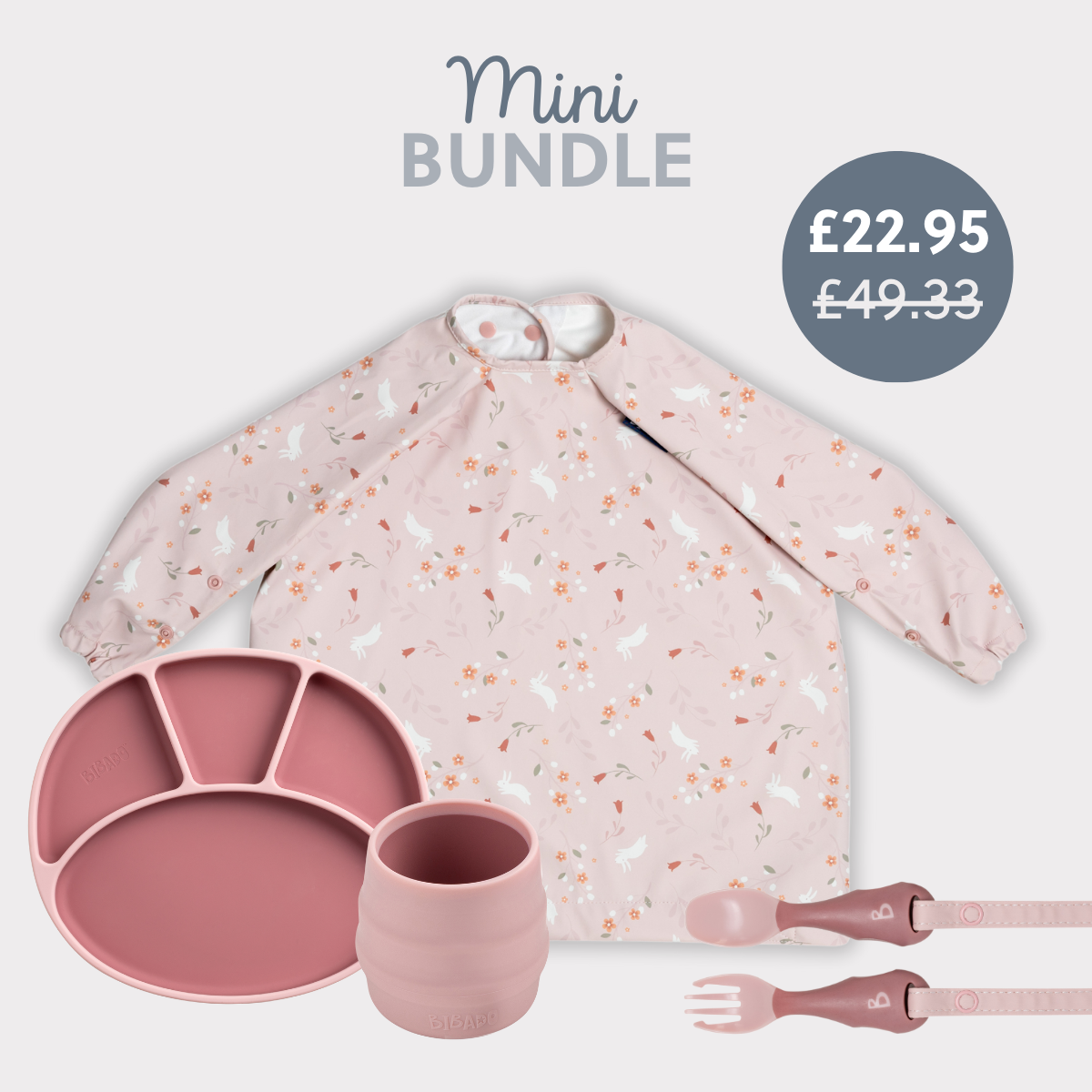 Pink silicone baby feeding set: divided plate, cup, fork, spoon, and long-sleeved bib with bunny print. - Product image