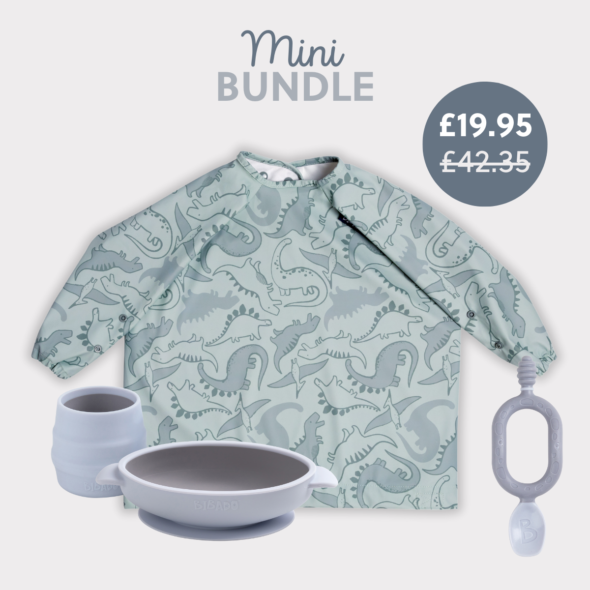 Pale green long-sleeved dinosaur print bib, grey silicone suction bowl, matching cup, and teething toy. - Product image