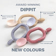 Three Dippit baby spoons in beige, grey, and pink, showing the deep contoured spoon, soft chewable dipper, and two-handed grip.
