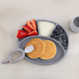Mist silicone divider plate with pancakes, strawberries, and blueberries on a light background