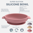 Pink silicone suction bowl with curved sides and secure base, ideal for baby's first meals.
